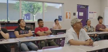 Parents sitting at desks