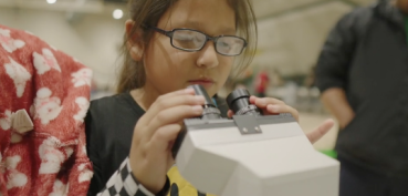 Student looking through microscope