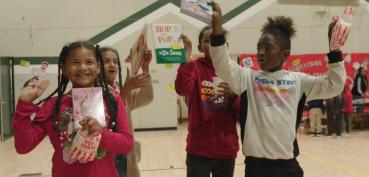 Students holding up books