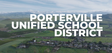 Porterville Unified School District text with farmland in background